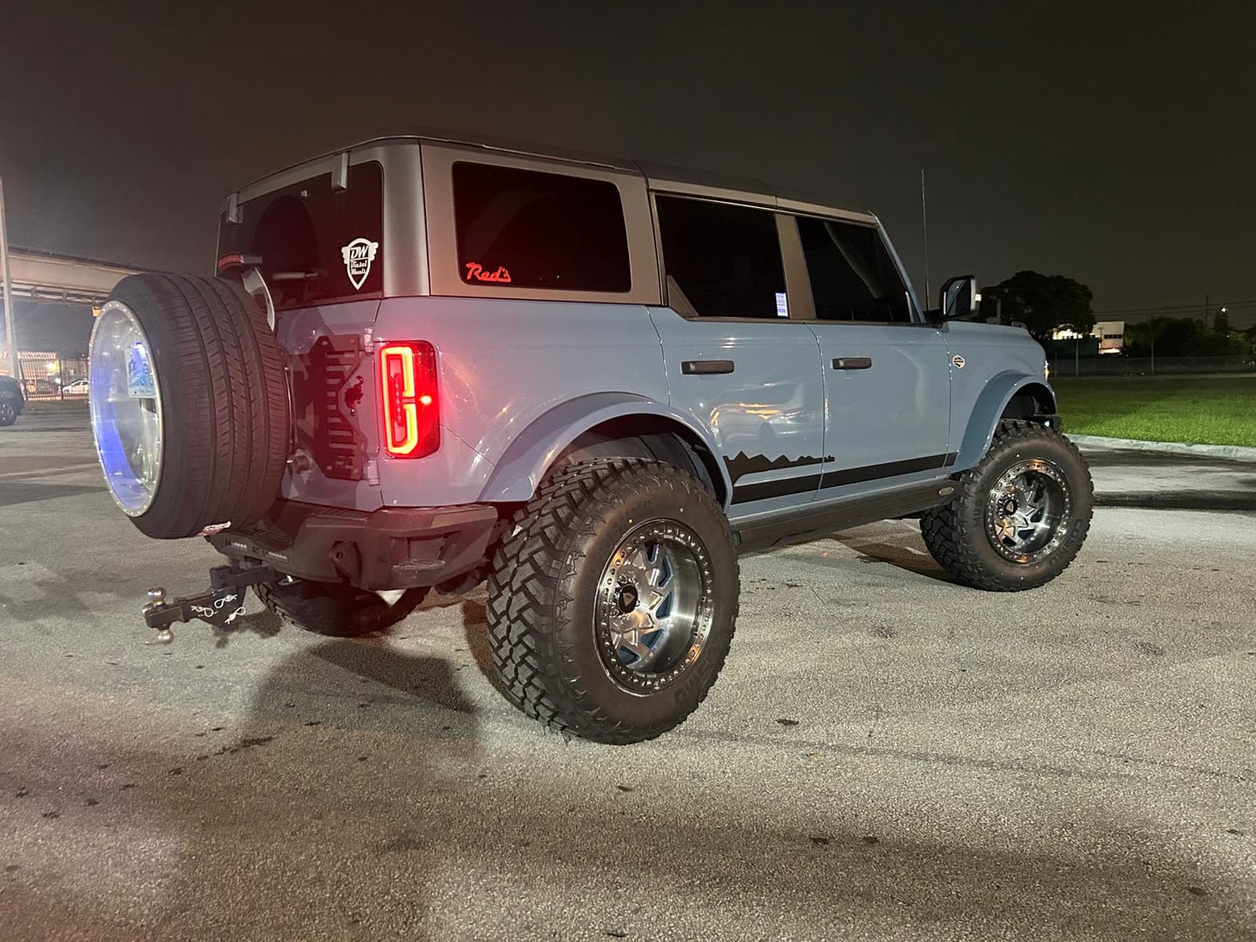 White lifted Ford Bronco with polished forged wheels