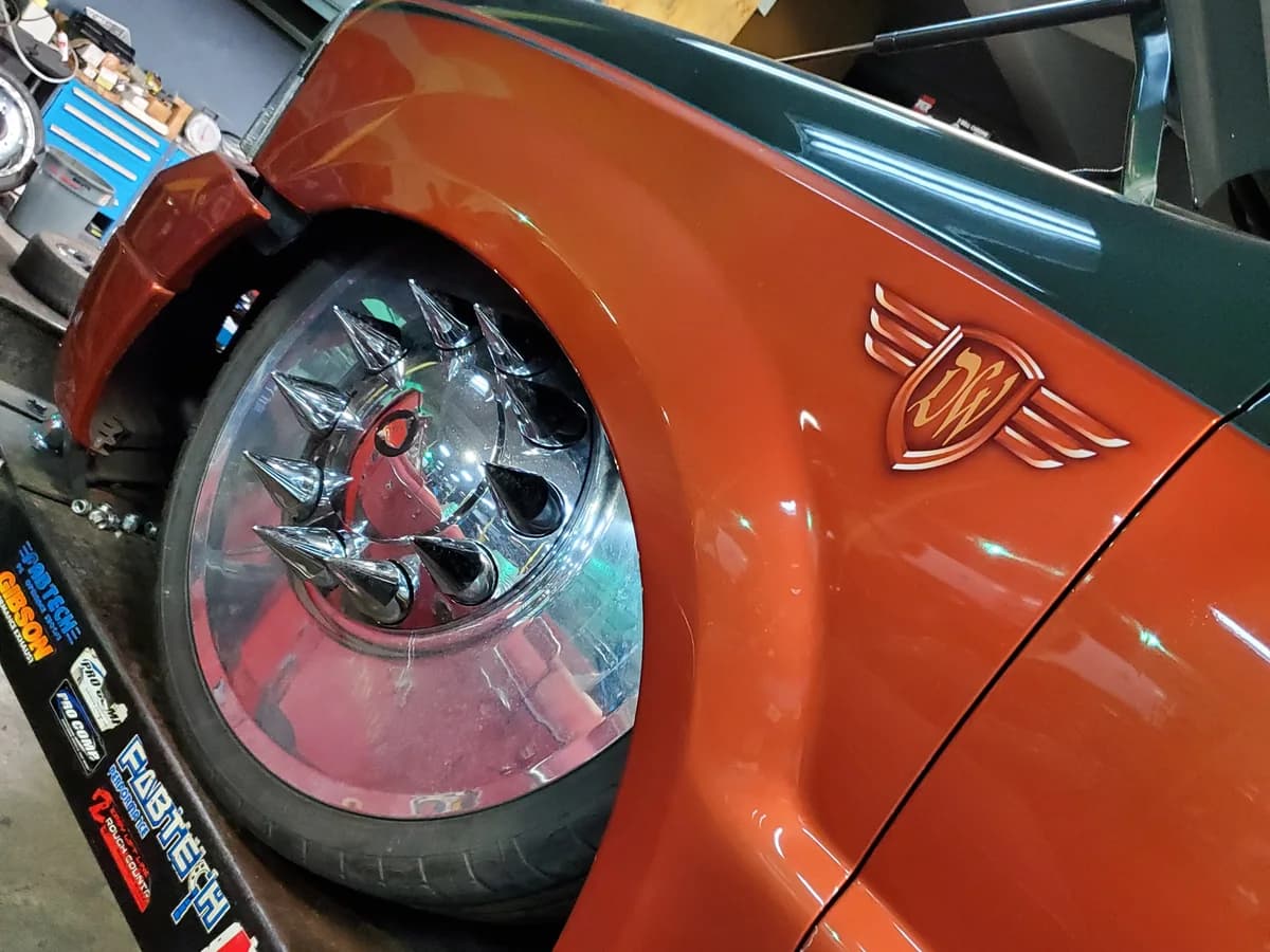 Close-up of a chrome Diesel Wheels truck wheel on a red custom truck in the Miami shop