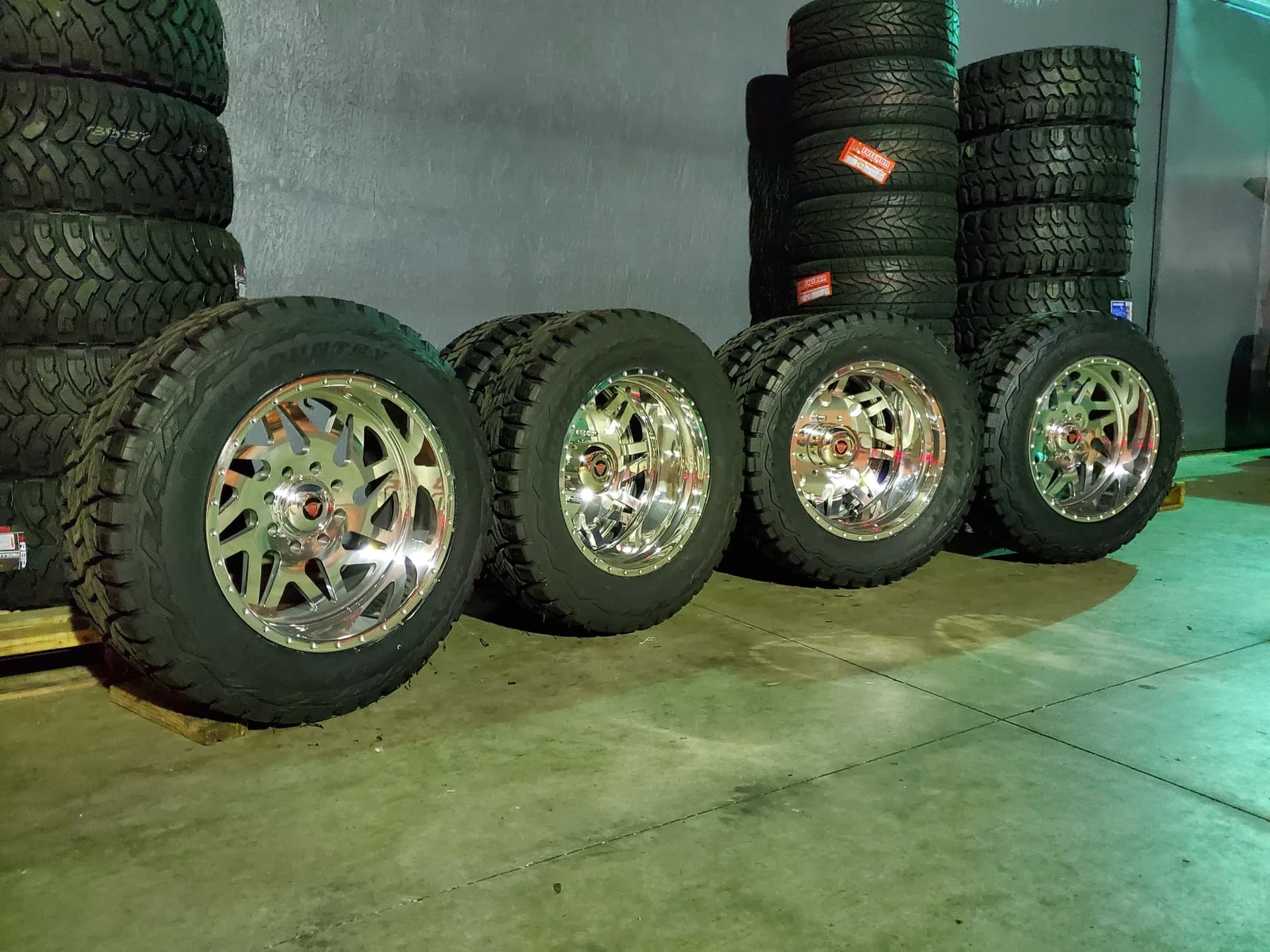 Polished wheels and off-road tires displayed inside the Diesel Wheels shop