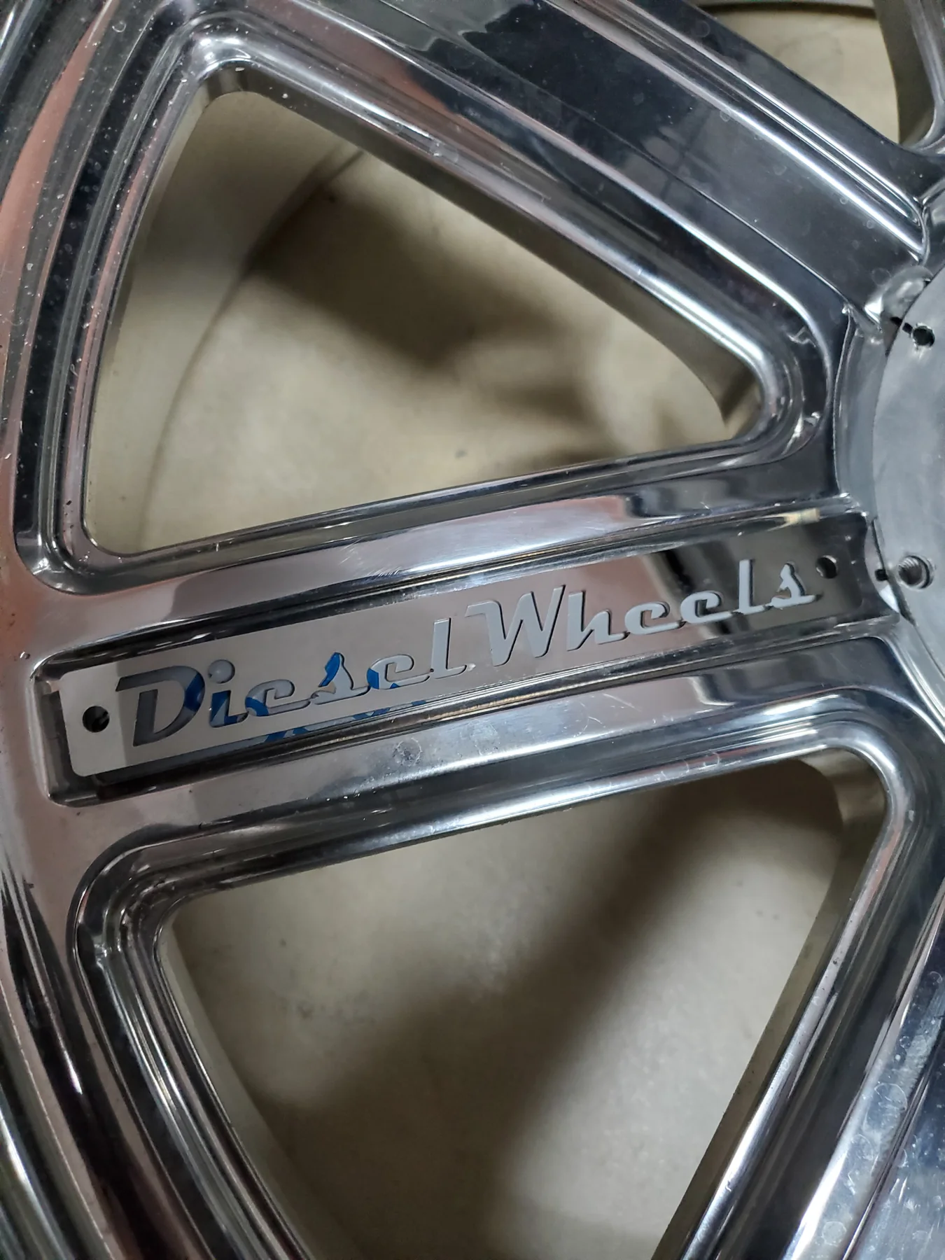 Close detail of polished Diesel Wheels lettering on a custom wheel