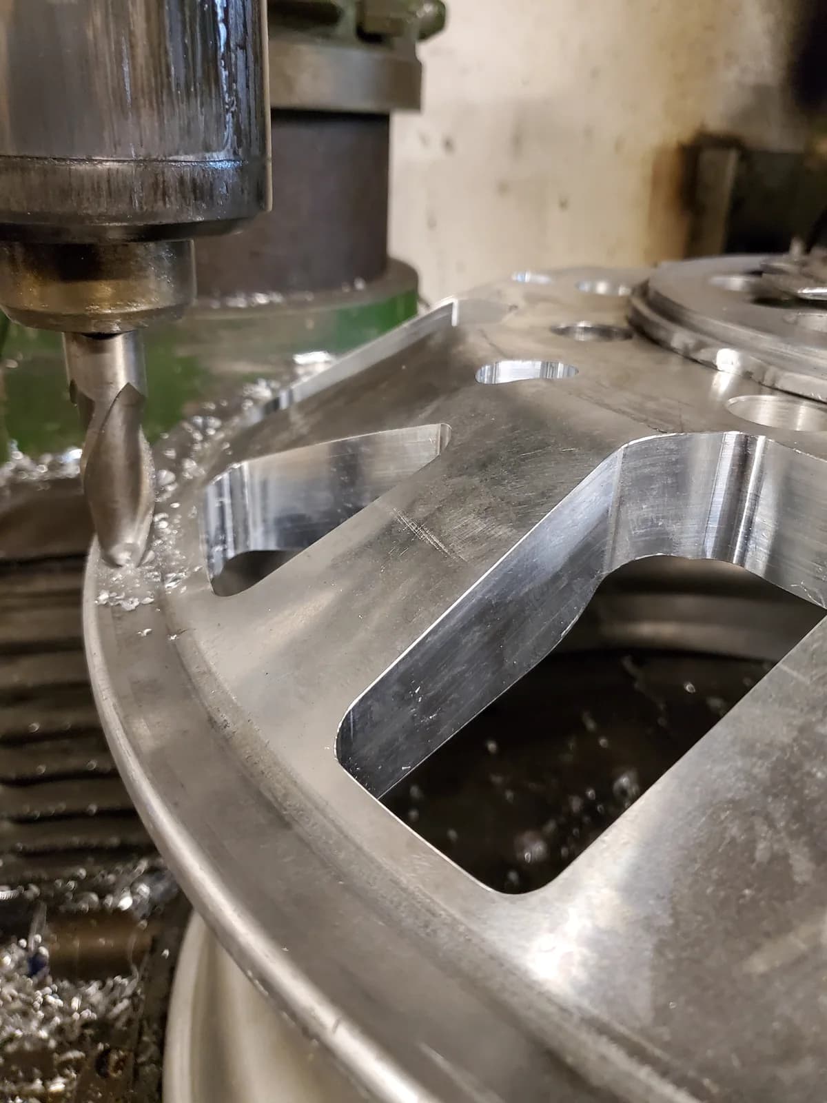 A cutting tool machining the face of a forged aluminum wheel